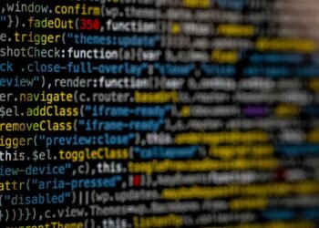 Yellow and blue data code displayed on screen by markus-spiske